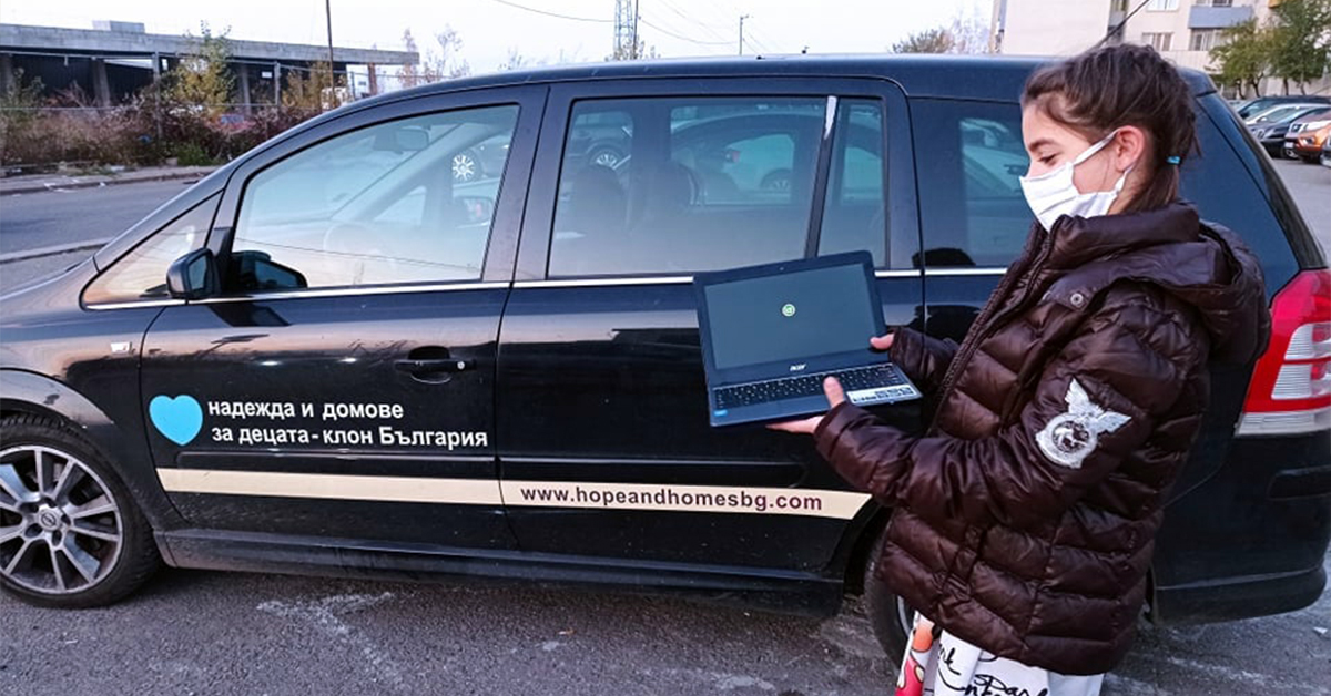 A member of Anglof Regional Foundation & Humanitarian Relief Agency (ARFHRA) Bulgaria team with a laptop, ready to give away
