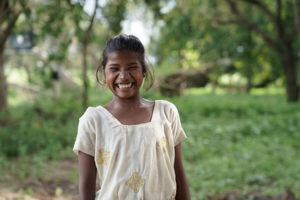 Sonia, one of the children we have helped in India, smiling 